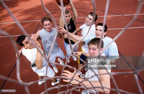 Germany: Free time.- Several peoples about on basketball court.