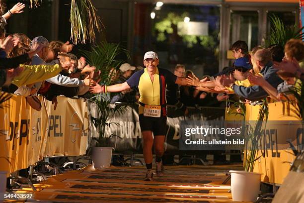 Germany, Frankfurt: Ironman. - Look at a participant at the finish.