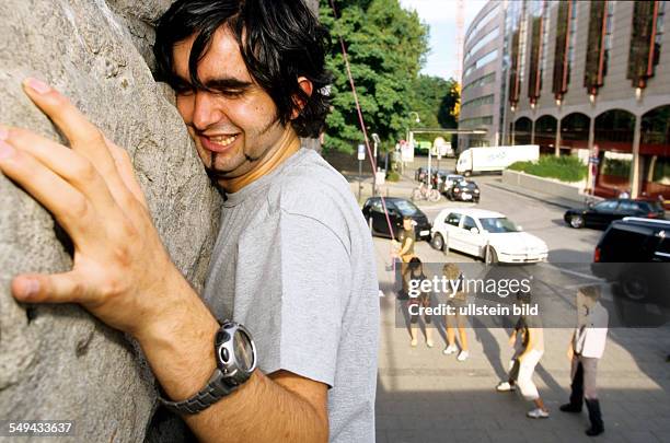 Germany: Free time.- Young man climbing.