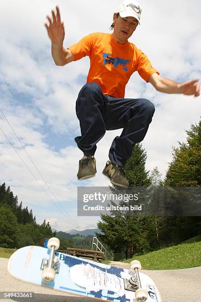 Germany, : A young man skateboarding.