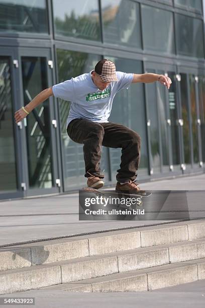 Germany: Young persons in their free time.- A young man is riding a skateboard.