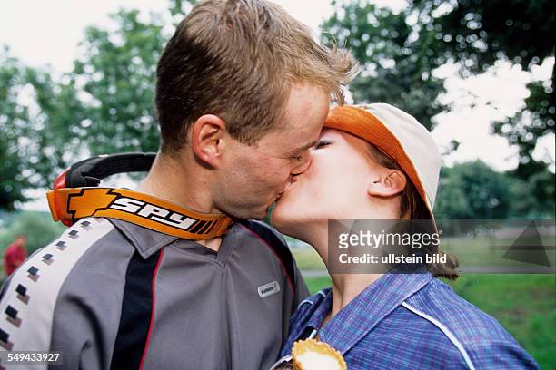 Germany: Free time.- A young couple kissing.