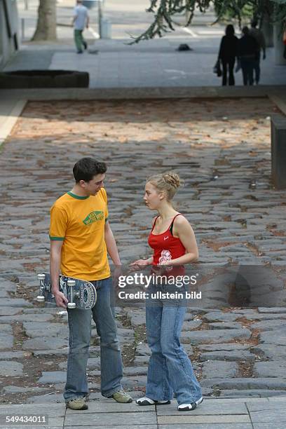 Germany, Cologne: Youth in their free time.- Two friends talking.