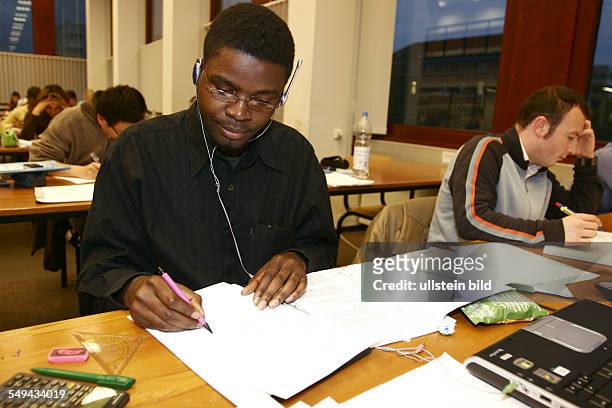 Germany, NRW Aachen: The mechatronics student Matondo - M Ngankia from the Congo is learning in the library.
