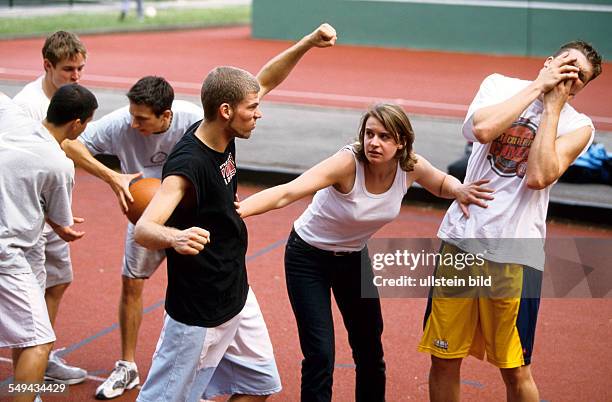 Germany: Free time.- Young men playing basketball; confrontation.