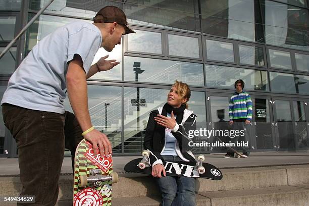 Germany: Young persons in their free time.- Friends are skateboarding.