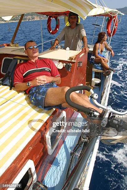 Turkey: A woman and a man during a boat trip on the sea.