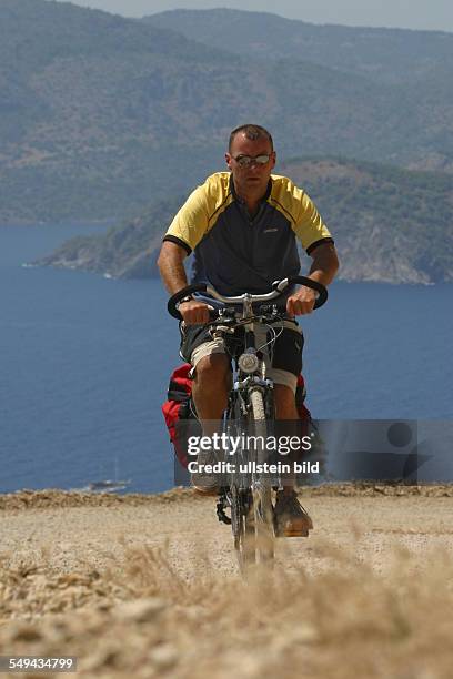 Turkey: A man during a bicycle tour in the mountains.