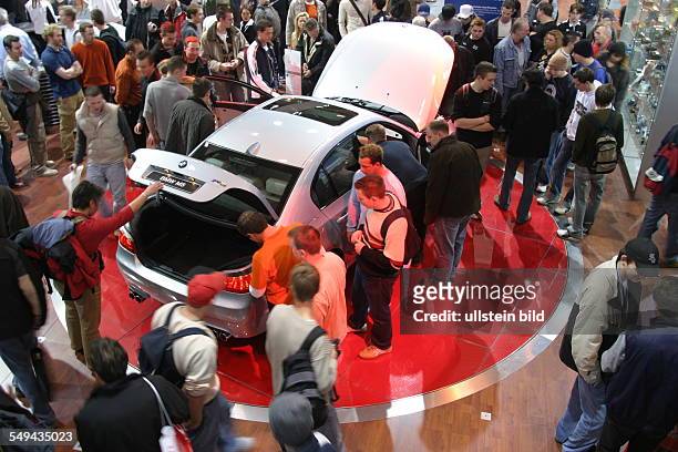 Germany, Essen: EMS - Essen Motor Show.- International fair for automobiles, tuning and classics; visitors at the stand of BMW.