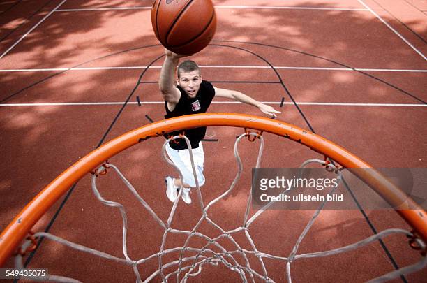 Germany: Free time.- A young man playing basketball.
