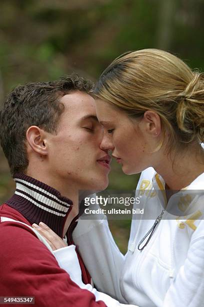 Germany, : A young couple kissing.