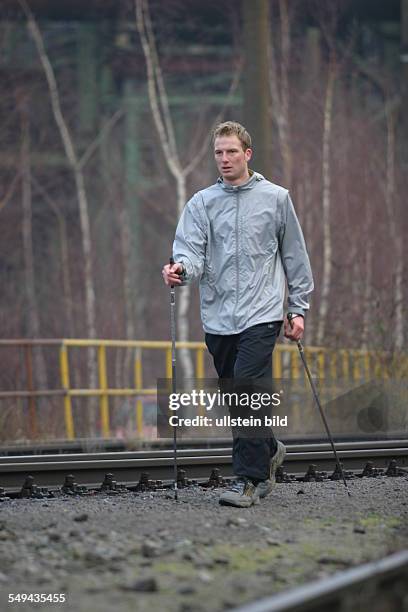 Germany, Duisburg: Nordic Walking.- A young man in the landscape park Duisburg-North. Model Release: Yes