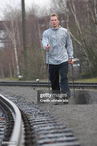 Germany, Duisburg: Nordic Walking.- A young man in the landscape park Duisburg-North. Model Release: Yes