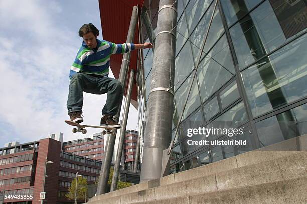 Germany: Young persons in their free time.- A young man is riding a skateboard.