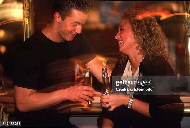 Germany: Bowling.- A couple enjoying their time at the bar.