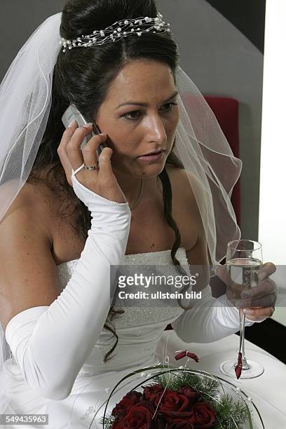 Germany: The bride hanging on her cellular phone.