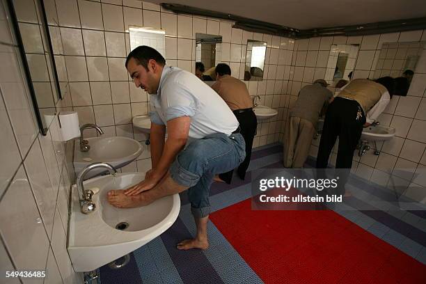 Germany. Yildiray Kara, 34 years, police inspector with turkish origin. Friday prayer in the mosque. Yildiray Kara is preparing himself for the...