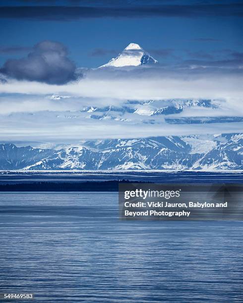 mt. st. elias towers over the coast in alaska - mount saint elias stock pictures, royalty-free photos & images