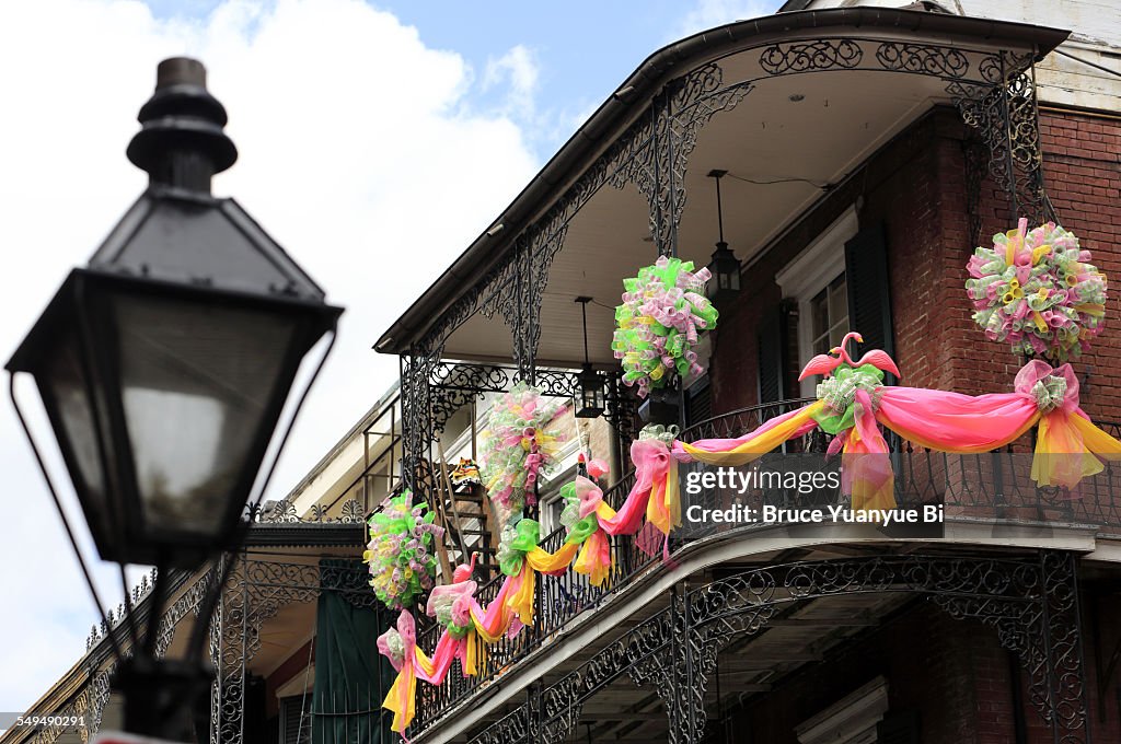 Mardi Gras decorations on a wrought iron balcony
