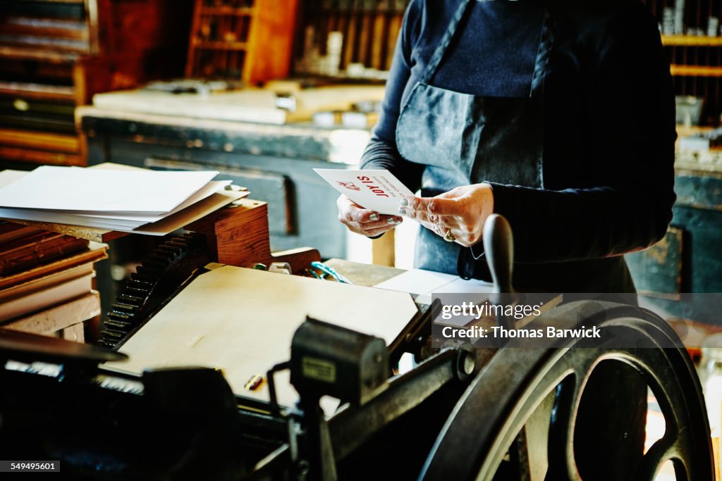 Female printer in studio examining proof print