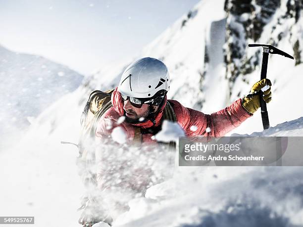mountain climber in a snow storm. - winter sport stock-fotos und bilder