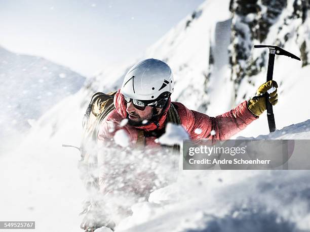 mountain climber in a snow storm. - mountain climb stock pictures, royalty-free photos & images