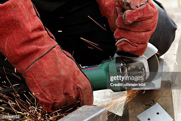 Man cutting metal with a angle grinder