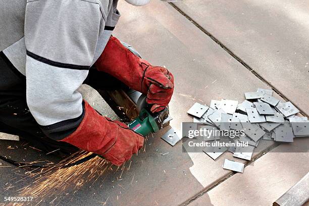 Man cutting metal with a angle grinder