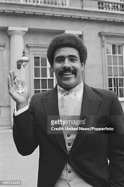 English decathlete Daley Thompson pictured holding his MBE award at an investiture ceremony at Buckingham Palace in London on 20th July 1983.
