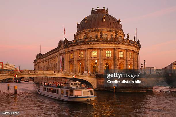 Germany - Berlin - Mitte: the museum "Bode-Museum" on Museum Island with river Spree and an excursion boat in the evening