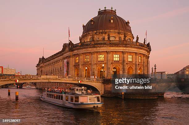 Germany - Berlin - Mitte: the museum "Bode-Museum" on Museum Island with river Spree and an excursion boat in the evening