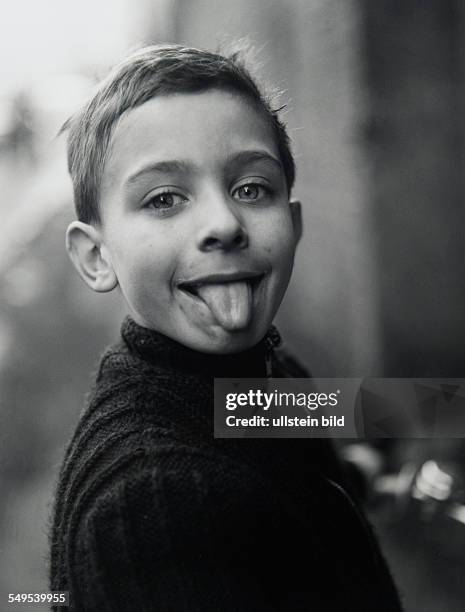 Germany, Essen, Ruhr area, boy sticking out his tongue