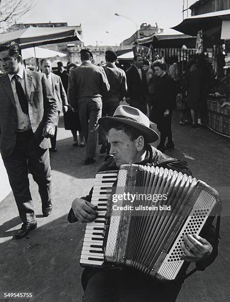 Italy, Rome, blind accordion player at Porta Portese market