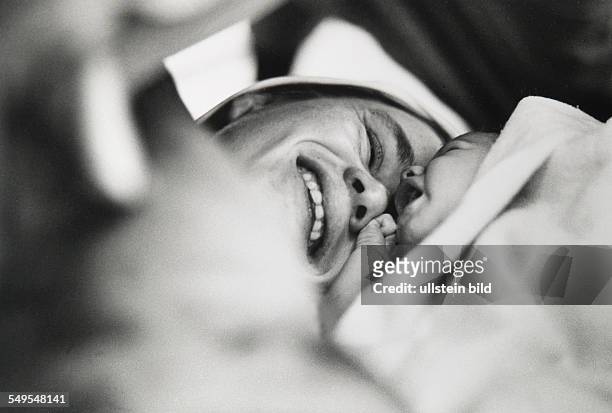 Germany, Hamburg, birth, happy mother with new born baby in her arms.