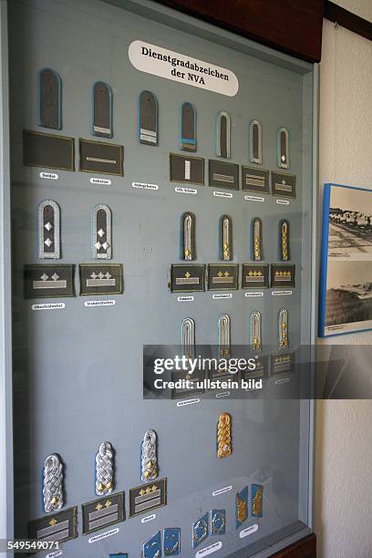 Cottbus: Presentation board with the service grade badges of the Nationale Volksarmee of the former GDR. Inside the Cottbus Airport museum. History...