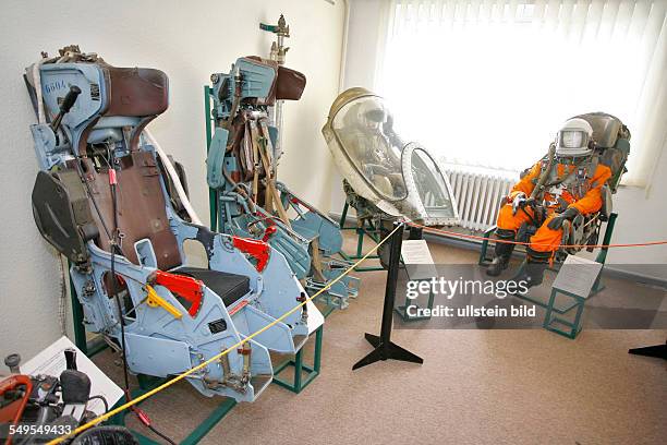 Cottbus: Ejection seats and other pilot seatings inside the Cottbus Airport museum. History of the airport Cottbus from early flights in 1913, World...