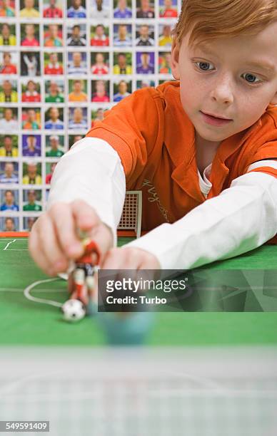 boy playing table soccer - action figure imagens e fotografias de stock