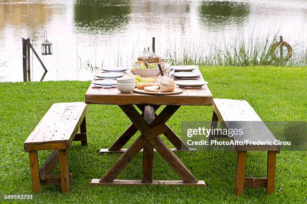 picnic table set for meal outdoors - picnic table park stock pictures, royalty-free photos & images