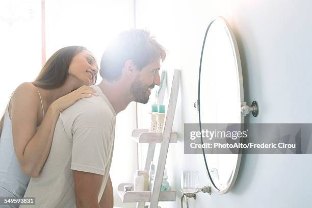 couple sharing lighthearted moment together - badezimmer mann stock-fotos und bilder