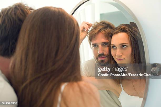 woman suggesting husband needs haircut - haare mann stock-fotos und bilder