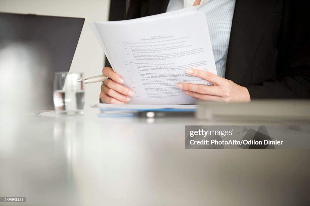 Executive reviewing document, cropped