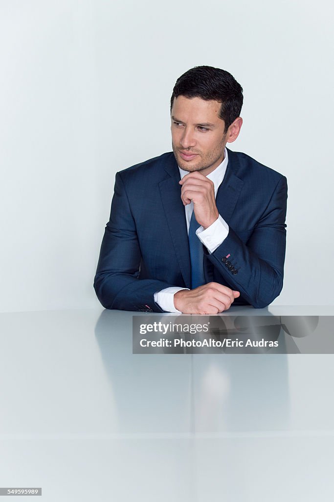 Businessman looking away in thought, portrait