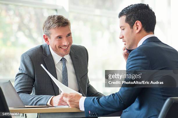 businessmen discussing documents in meeting - business man sitting banking imagens e fotografias de stock