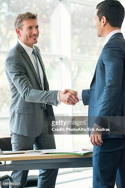 businessmen shaking hands in office - lawyer handshake stock pictures, royalty-free photos & images