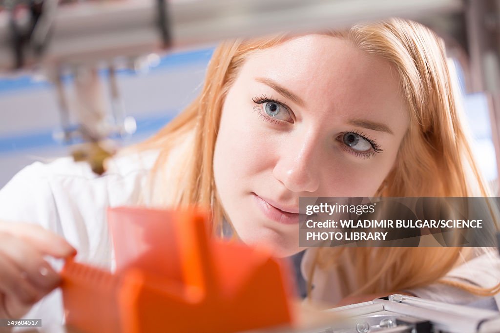 Female student using 3d printer