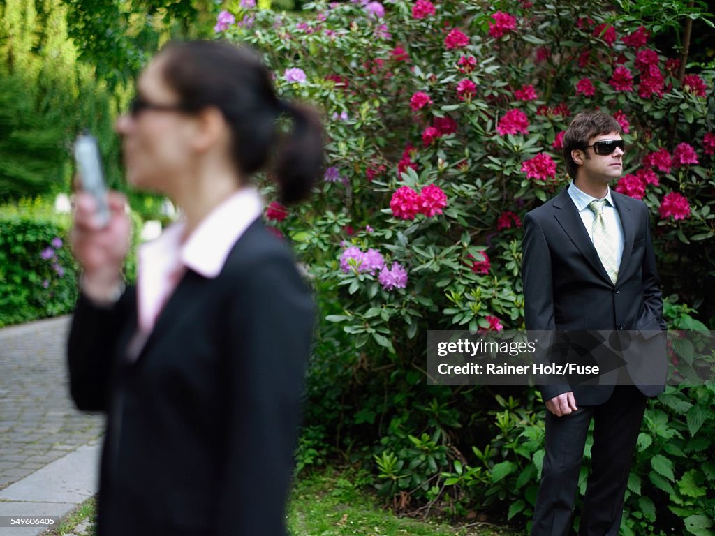 Businesswoman and Businessman Outside Country House