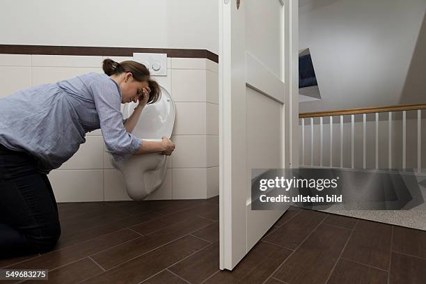 Young pregnant woman, 35 years old, feeling sick on a toilet.