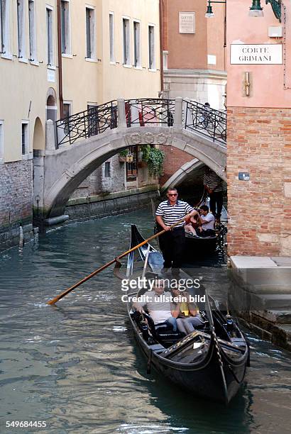 Gondolas on a side canal in Venice.