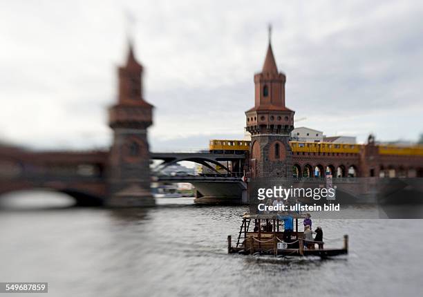 Berlin, Oberbaumbrücke und die Spree, junge Leute schippern mit einem Boot umher