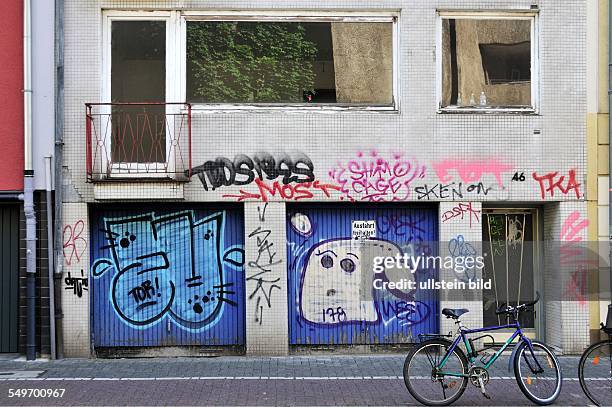 Ein mit Graffiti verschmiertes Reihenhaus mit Garagen